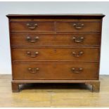 A George III oak chest, having a brushing slide, above two short and three long graduated drawers,