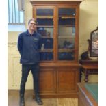 A near pair of 19th century oak bookcase cabinets, having two glazed doors, on a base with two