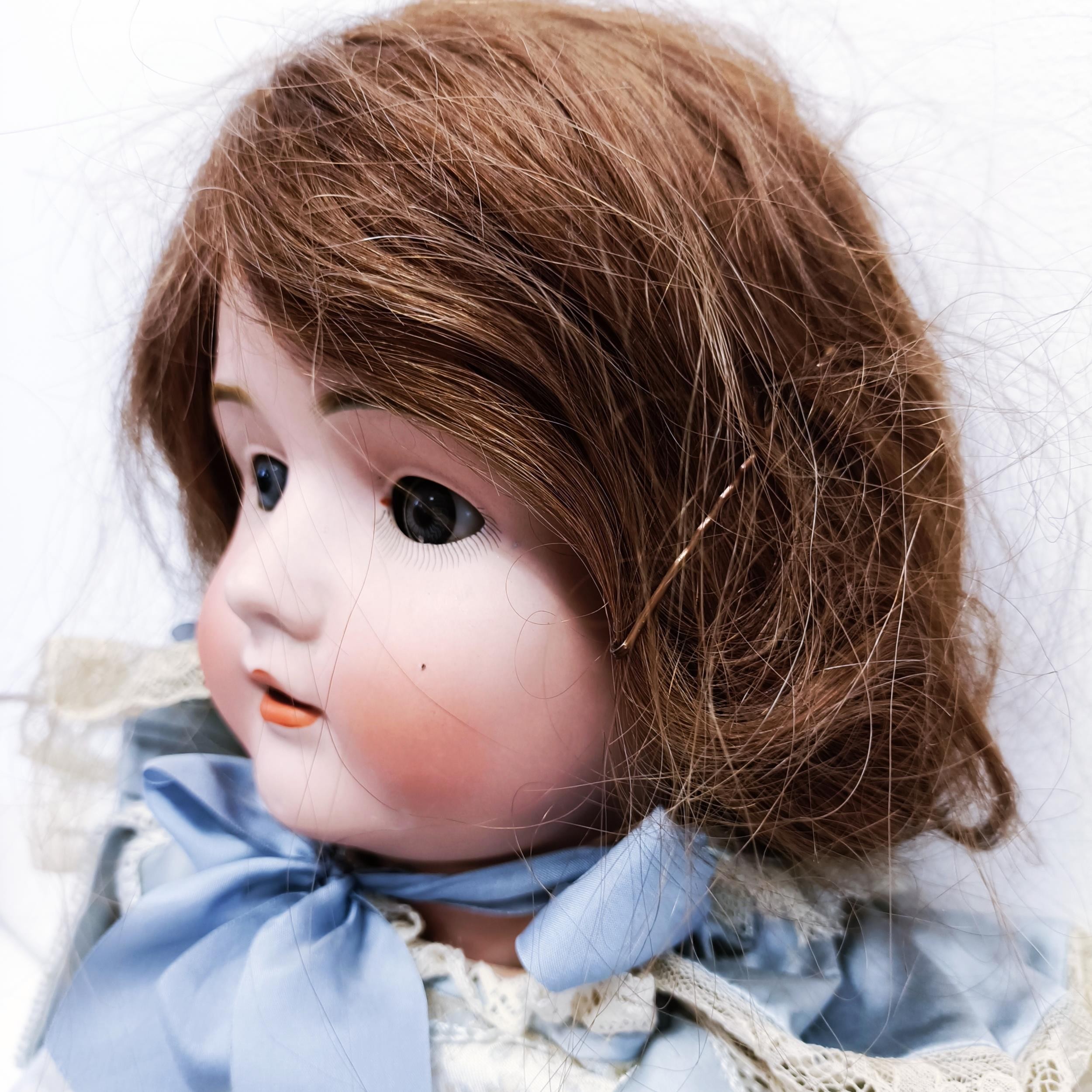 A German bisque headed doll, makers mark BSW, with a jointed composite body, millefiori closing