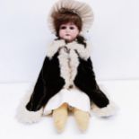 An Armand Marseille German bisque headed doll, No 370, with a cloth and composite body, and