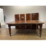 A 19th century mahogany extending dining table, on turned reeded legs, the top 130 x 146 cm, with