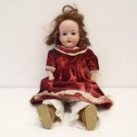 A Heubach German bisque headed doll, No 275.7/0, with a cloth and composite body, and millefiori