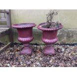 A pair of painted cast iron garden urns, of campagna form, 45 cm high