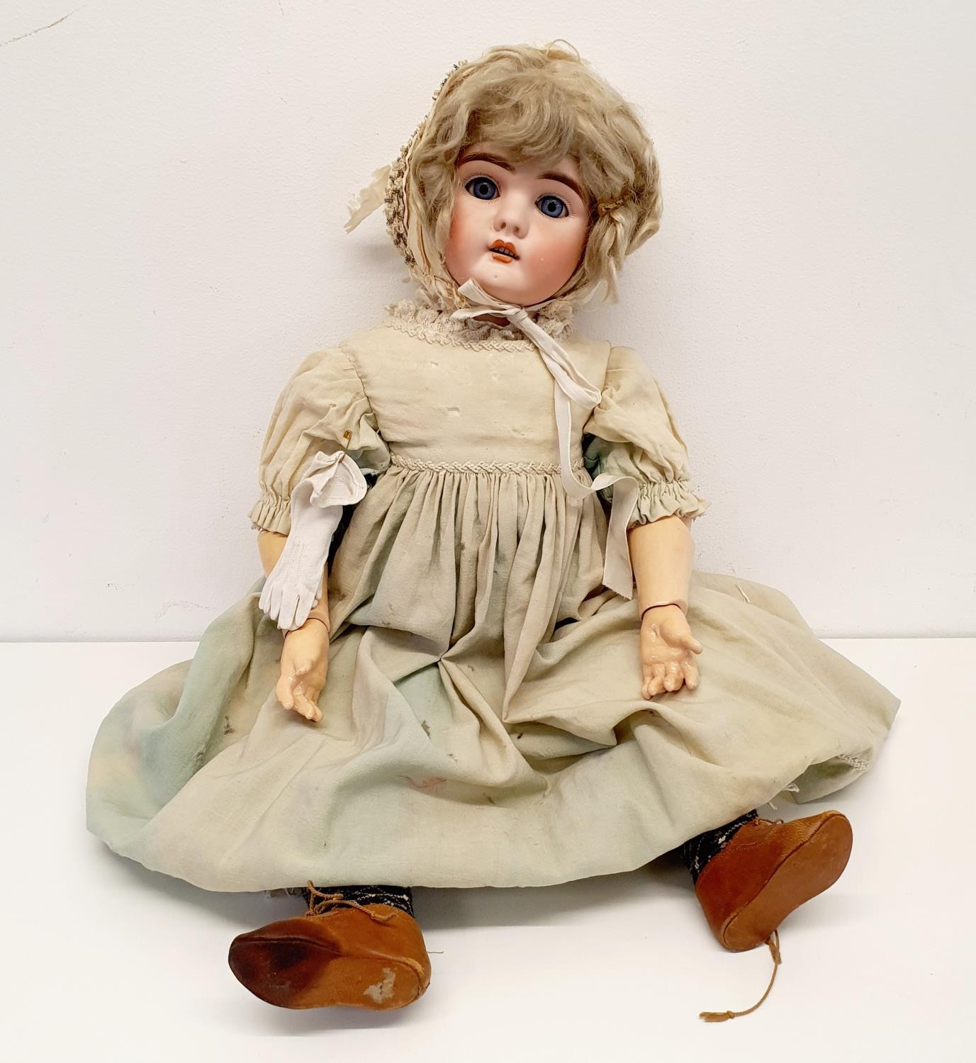 A German bisque headed doll, with jointed composite body and millefiori glass closing eyes, 60 cm