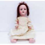 An Armand Marseille German bisque headed doll, No 996, with a composite body, millefiori closing