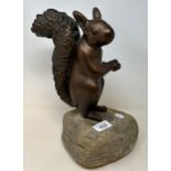 A bronze squirrel, on a carved stone base, 32 cm high