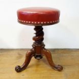 A 19th century rosewood adjustable piano stool, with a red leather seat, 34 cm diameter