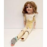 A German bisque headed doll, makers mark H, with a jointed composite and leather body, and