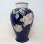 A Royal Doulton vase, decorated roses, 31 cm high No chips cracks or restoration found