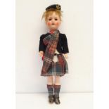An Armand Marseille German bisque headed doll, No 390, with a composite body, in a Scottish