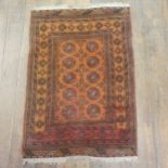 A Persian orange ground rug, 123 x 88 cm