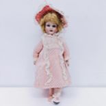 An Armand Marseille German bisque headed doll, No 390, with a composite jointed body, closing