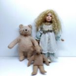 A modern bisque headed doll, 62 cm, a plush blonde teddy bear, a well loved teddy bear, and assorted