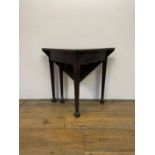 A 19th century mahogany folding triangular table, on square tapering legs to spade feet, 87 cm wide