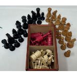 A red stained and natural bone chess set, the king 11 cm high, and a black and natural wood chess