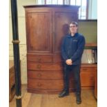 A 19th century mahogany bow front linen press, 226 cm high x 138 cm wide