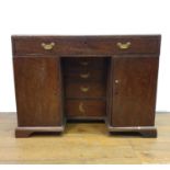 A 19th century mahogany kneehole desk, with a long drawer above three drawers, flanked by two