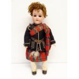 An Armand Marseille German bisque headed Scottish Boy doll, No 390, with a jointed composite body,