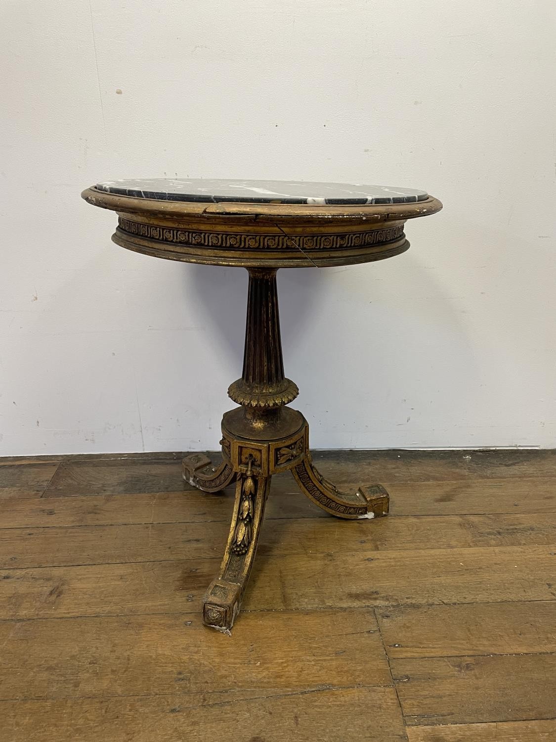 An Empire style carved wood and gesso gilt table, with a marble top, 64 cm diameter Various losses