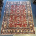 A Persian red ground rug, multiple borders, centre with repeating geometric motifs, 226 x 179