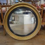 A large Regency style gilt gesso convex wall mirror, 104 cm diameter Has been restored, lacking