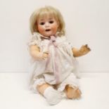 A Heubach bisque headed doll, No 300.6, with a composite body, and millefiori glass closing eyes, 52