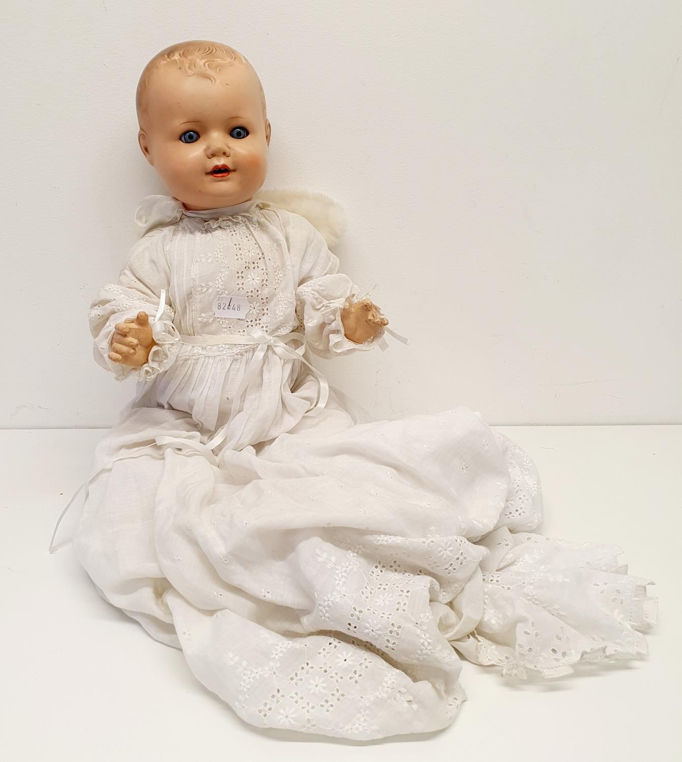 An Armand Marseille German bisque headed baby doll, with a composite body, and millefiori glass