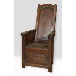 An oak lambing chair, with carved decoration