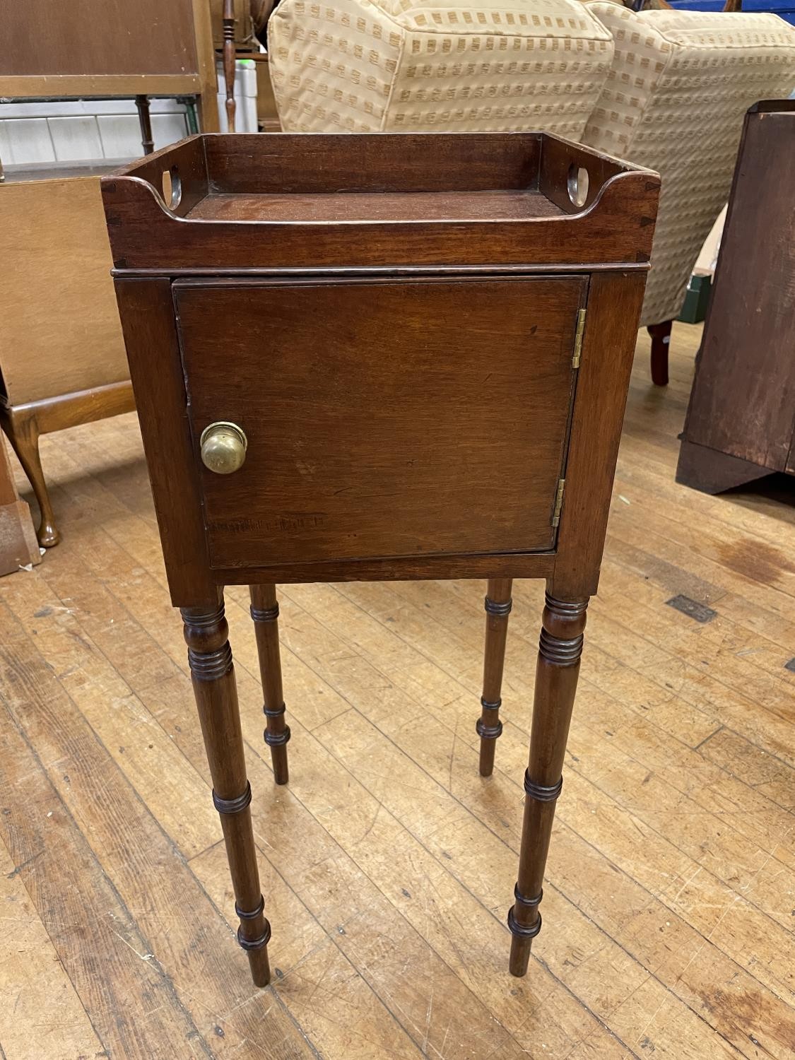 A 19th century mahogany tray top stand, with a single cupboard door, 30 cm wide