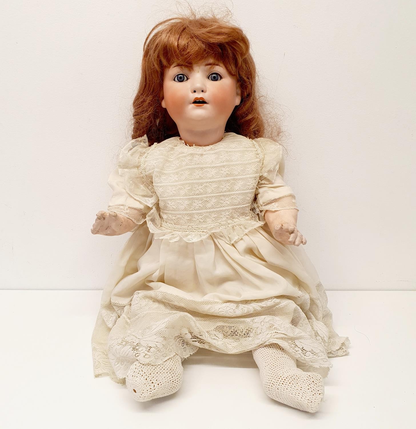 A Heubach German bisque headed doll, with a composite body, and millefiori glass eyes, 56 cm