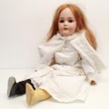 A Simon & Halbig German bisque headed doll, No 1299, with a jointed composite and wood body, 83 cm