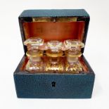 A shagreen and silver coloured metal perfume bottle box, hinged top to reveal three perfume bottles,