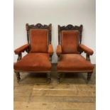 A pair of late 19th century library chairs, with carved oak frames, on turned reeded legs (2)