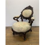 A Black Forest style carved oak armchair