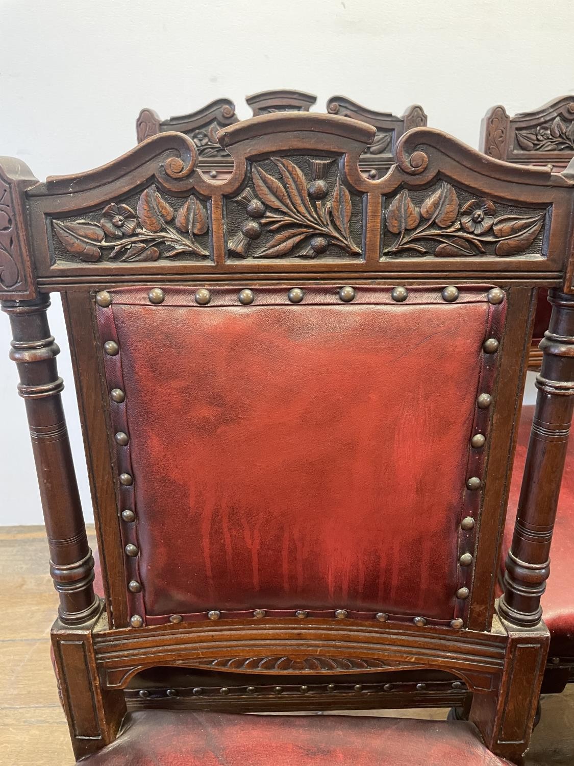 A set of six late 19th century carved walnut dining chairs, with leather padded backs and seats (6) - Image 11 of 11