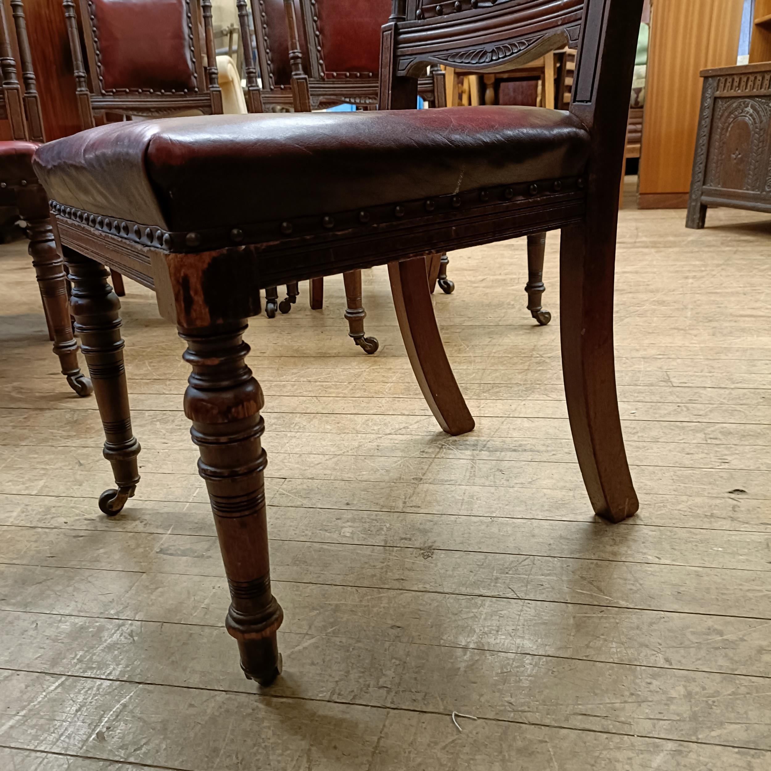 A set of six late 19th century carved walnut dining chairs, with leather padded backs and seats (6) - Image 9 of 11