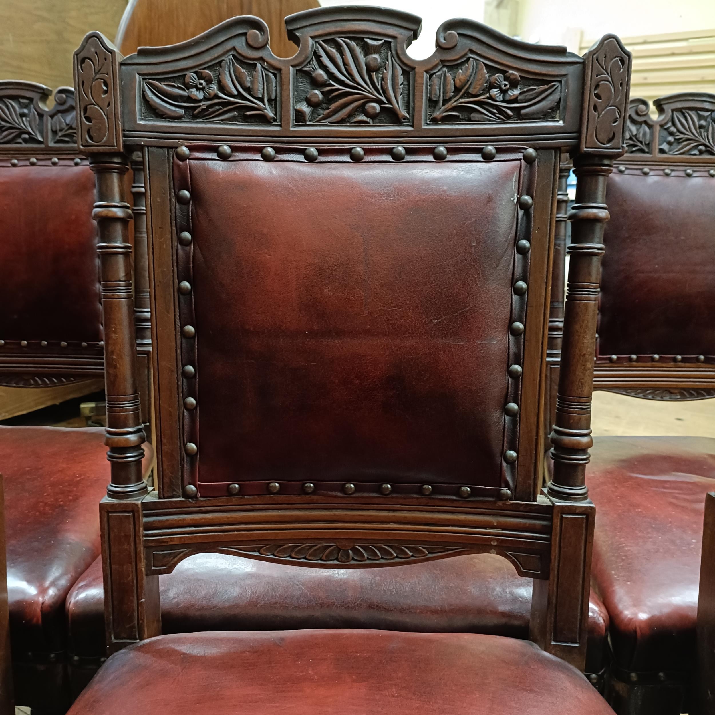 A set of six late 19th century carved walnut dining chairs, with leather padded backs and seats (6) - Image 5 of 11