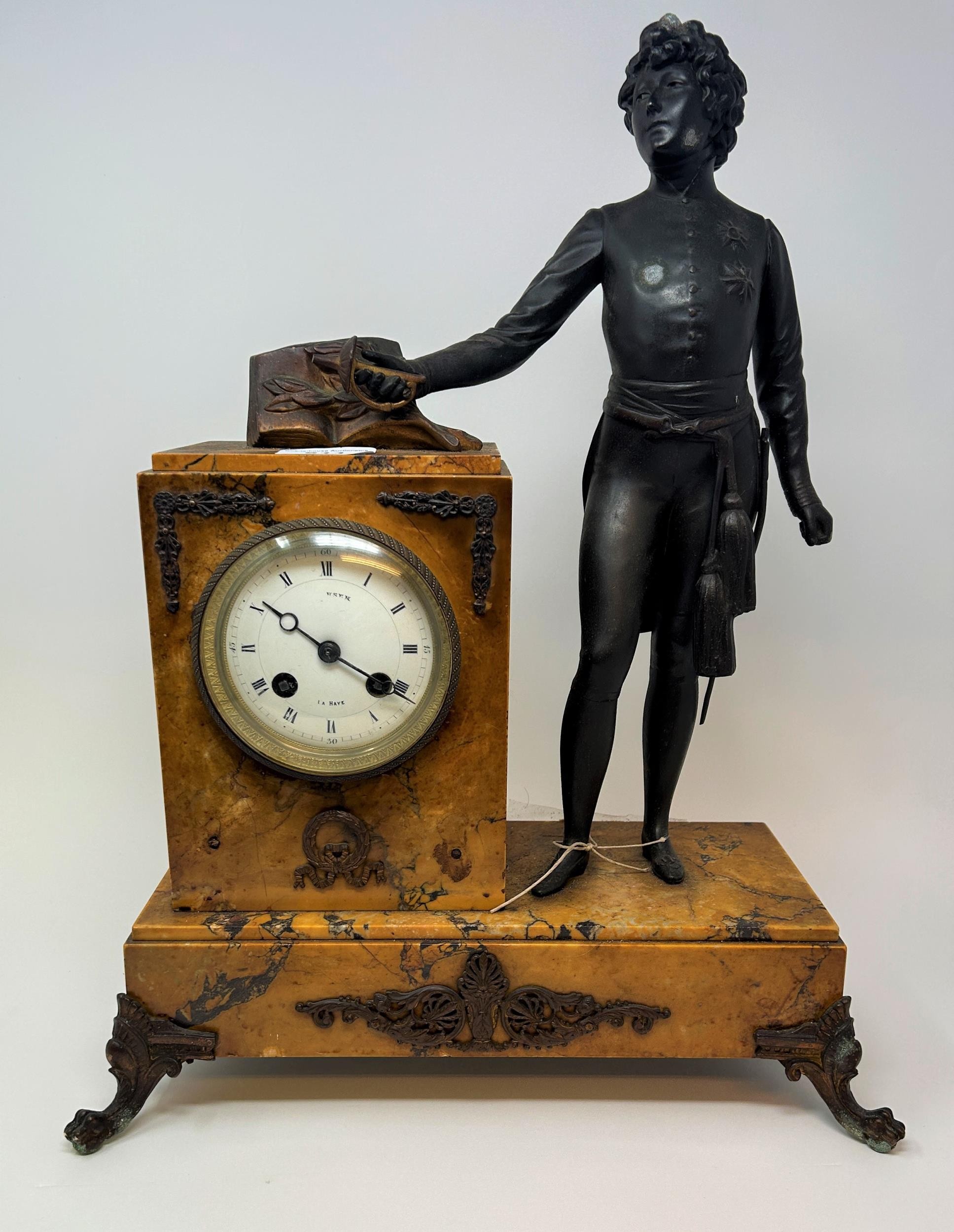 A late 19th/early 20th century French mantel clock, the 9 cm diameter enamel dial with Roman