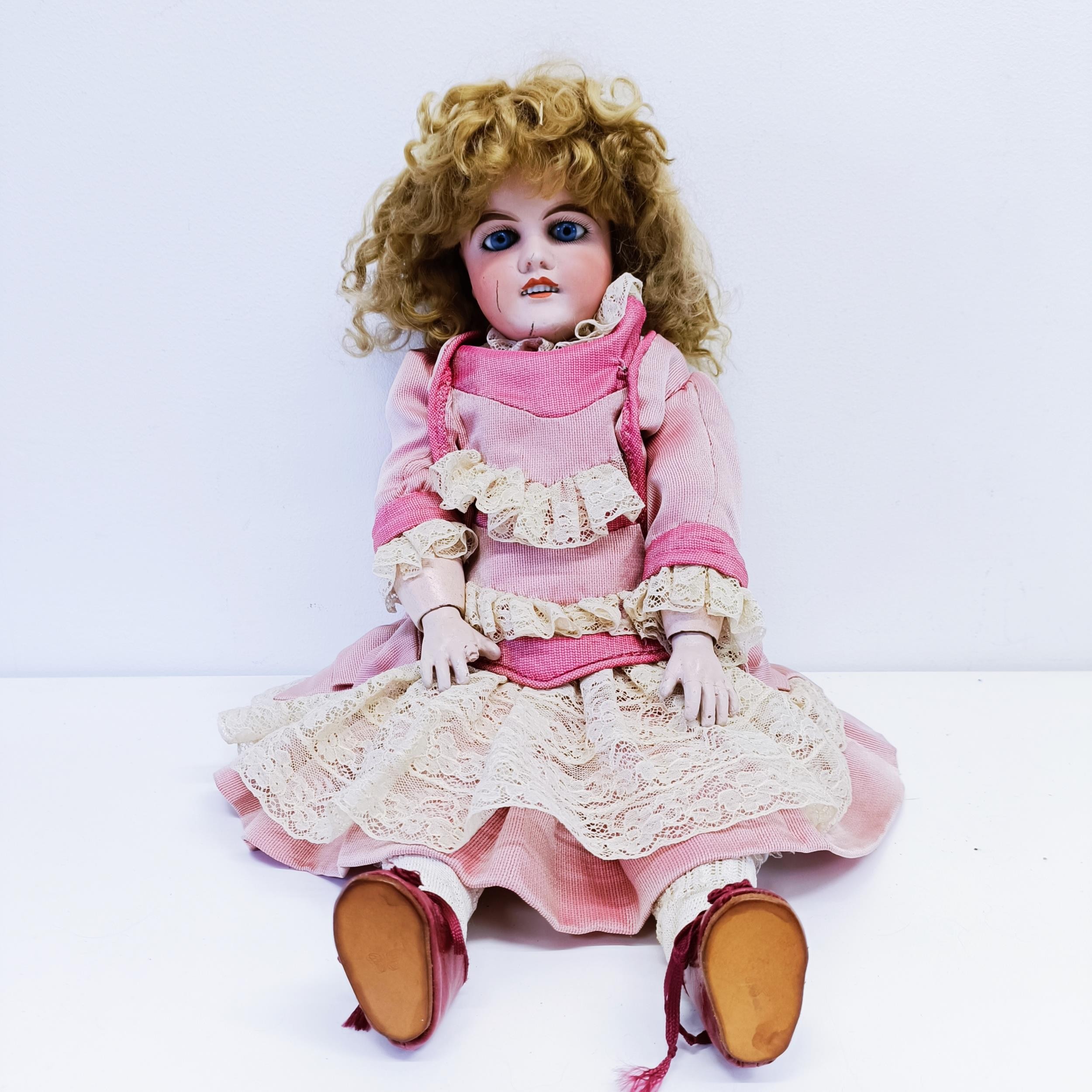 A Louis Leon Piere Mon Cheri French bisque headed doll, with a composite jointed body, and