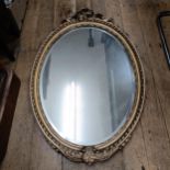 An early 20th century gilt gesso oval wall mirror, 100 x 70 cm Various losses