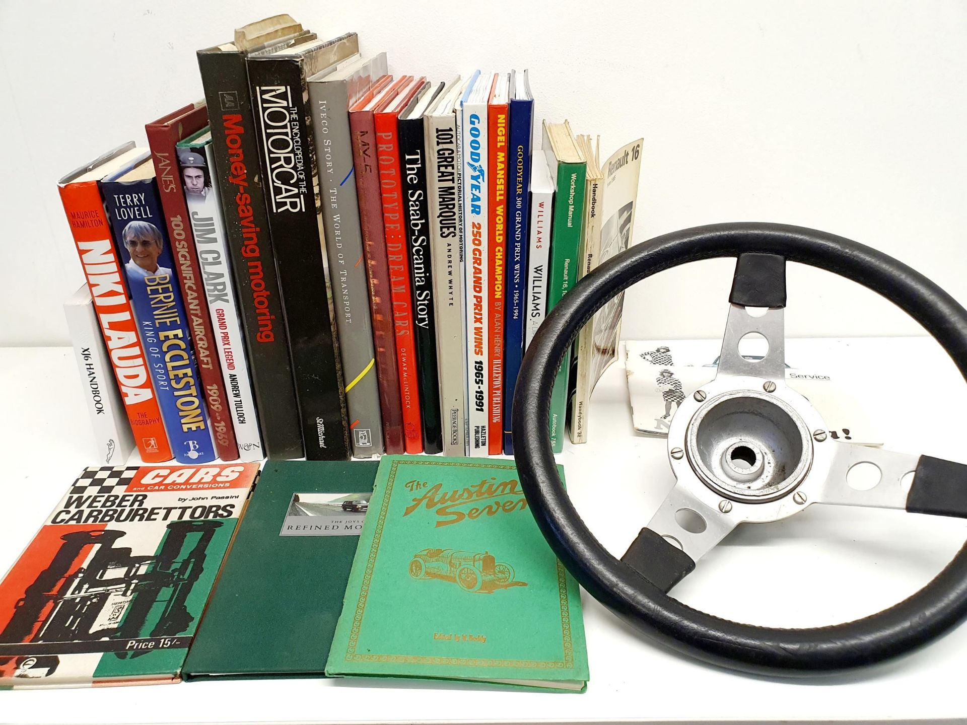 ***Withdrawn***The steering wheel from a Mini Cooper, assorted vehicle related books, a print, and a