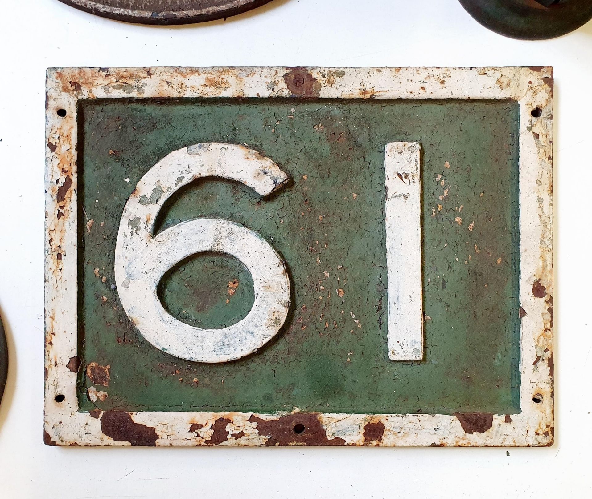 A painted cast iron locomotive/wagon number plate, 61 (or 19), 41 x 30 cm Very weathered