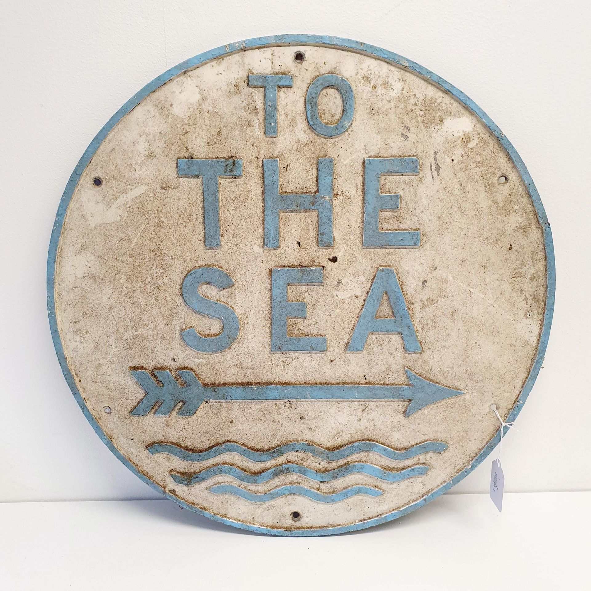 An aluminium sign, TO THE SEA, 46 cm diameter Garage stored, drilled with six holes, a small