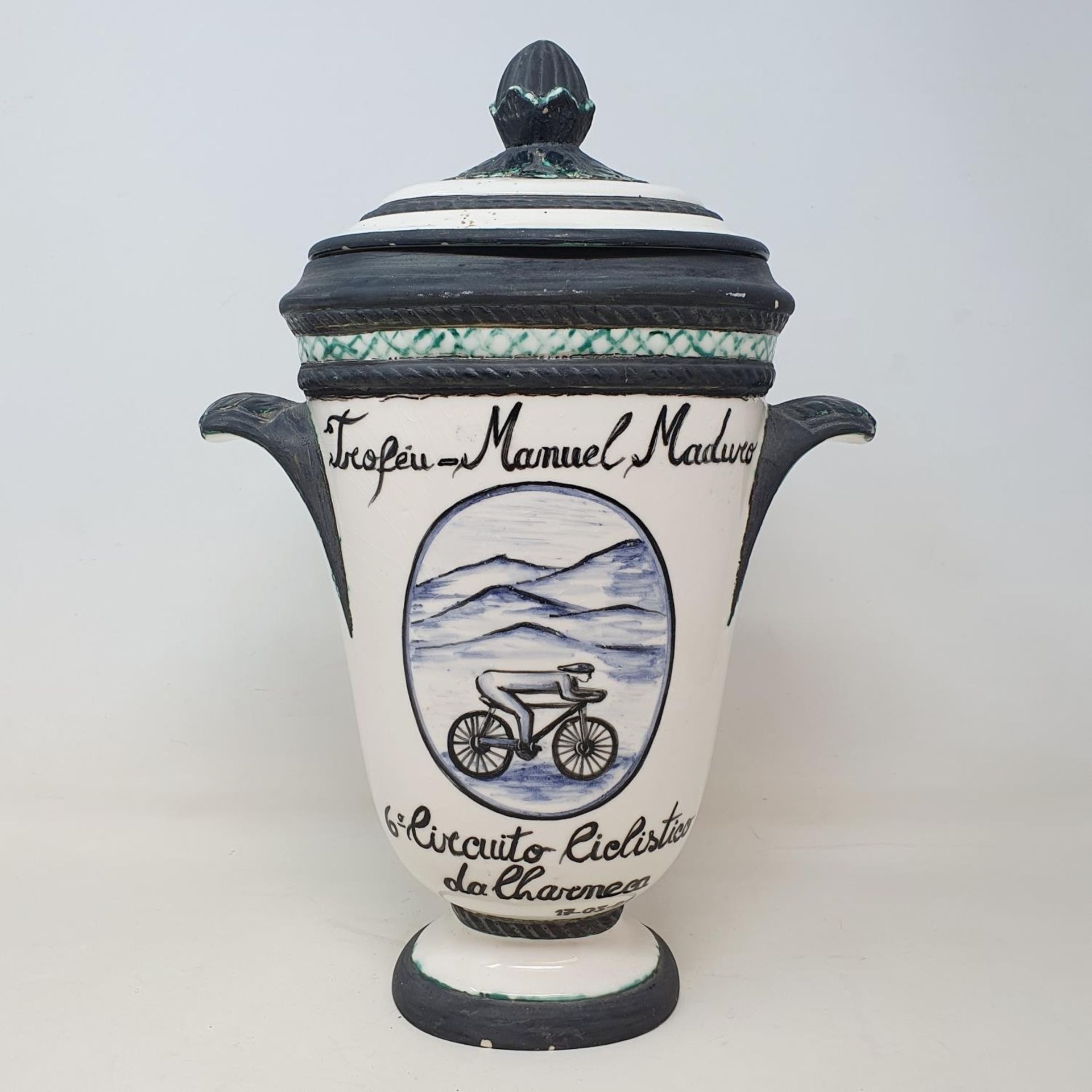 An Italian porcelain cycling trophy, 36 cm high, and a resin Hill Climb trophy in the form of a