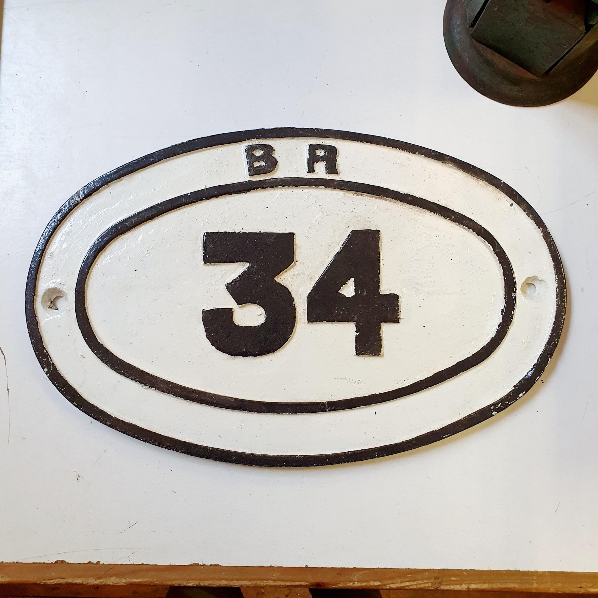 A painted cast iron British Rail locomotive/wagon number plate, 34, 29 x 46 cm Weathered