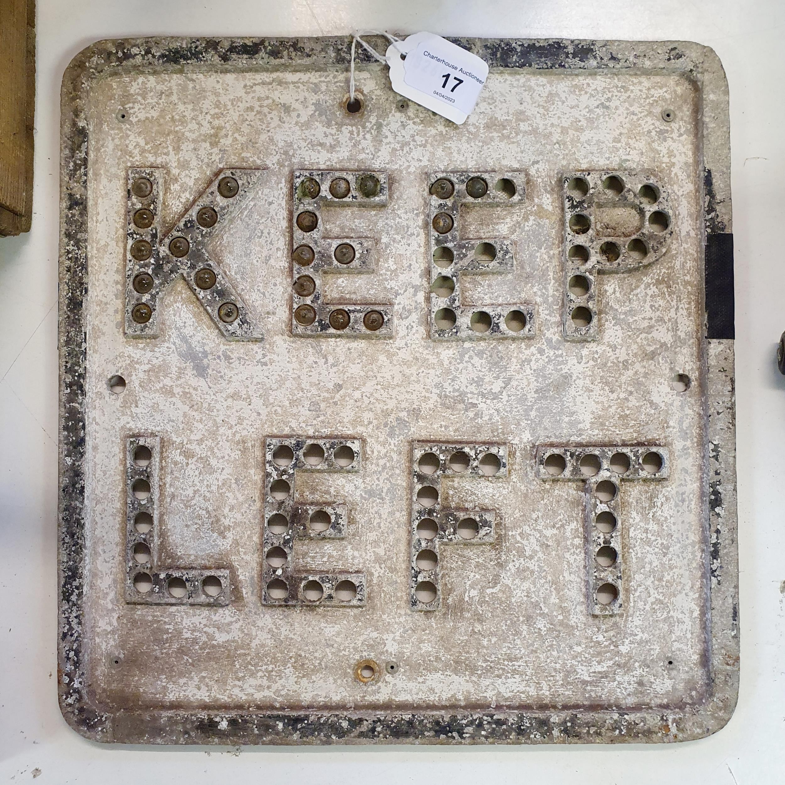 An early aluminium Keep Left sign, lacking paint and most of the reflectors, 33 x 30 cm