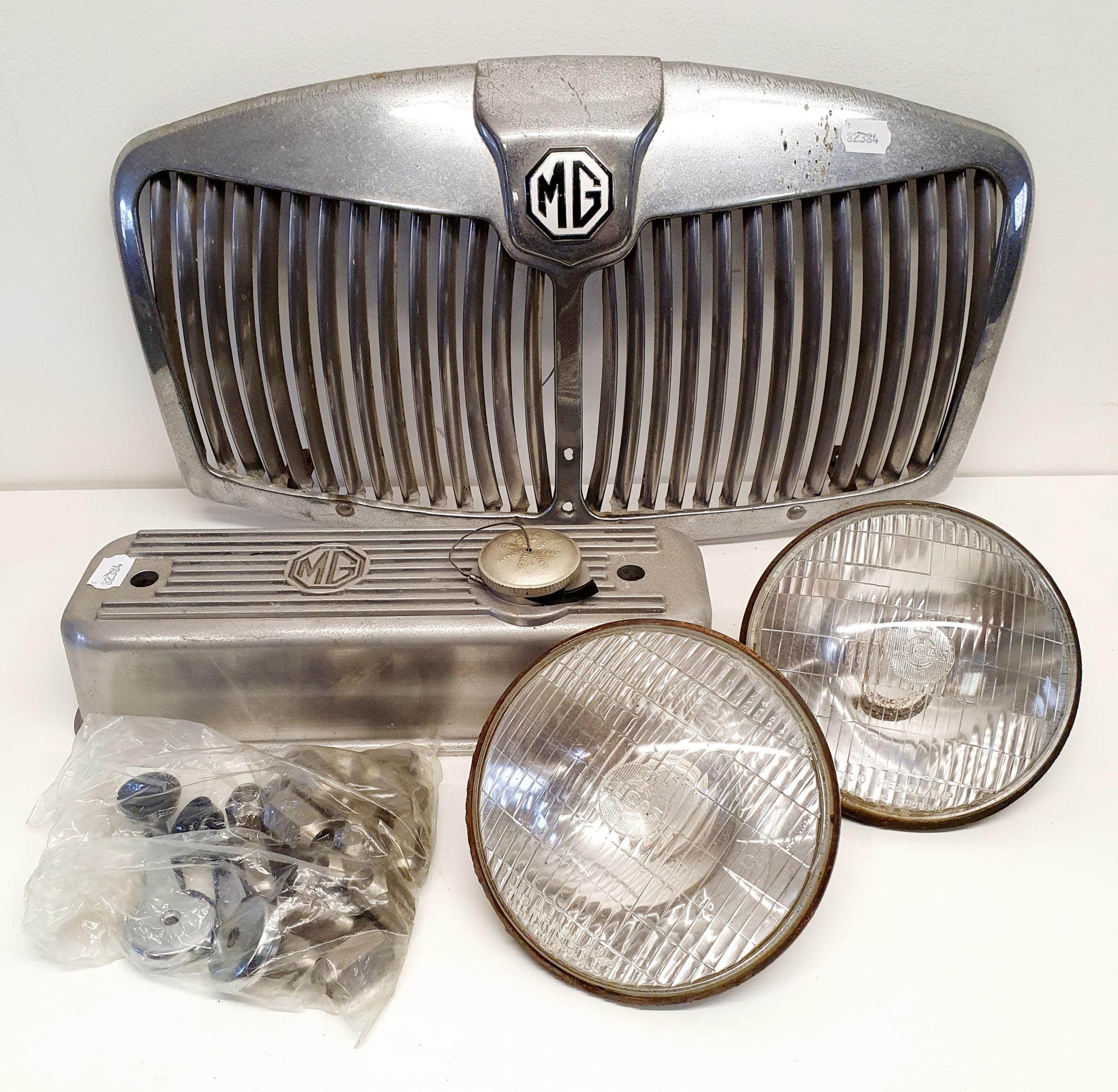 An MG A chrome radiator grill, a polished alloy rocker box cover, suitable for an MG B, with a