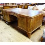 A Continental walnut kneehole desk, with a single drawer, flanked by two cupboard doors, 182 cm wide