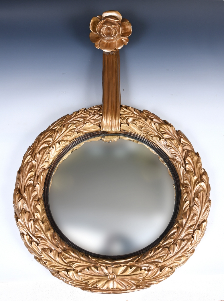 An unusual 19th century carved wood gilt framed mirror, with rose and ribbon finial, 66 cm