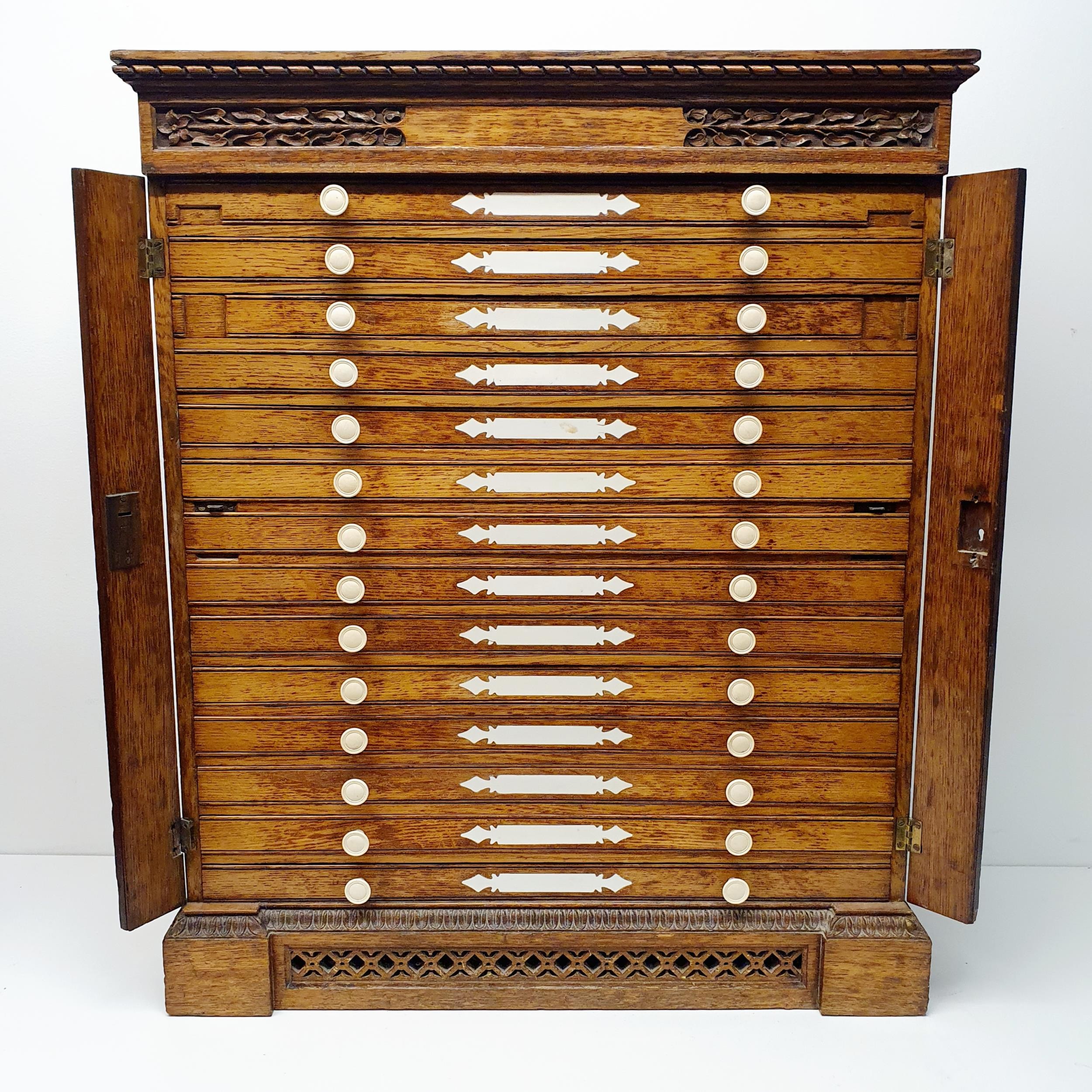 A late 19th century oak collectors chest, with a floral carved frieze, fourteen drawers, 70 cm x - Image 6 of 8